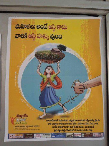 Poster mit Frau, die Heu balanciert, „Empower Her“, in Telugu-Schrift.
